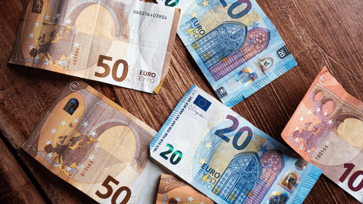 Des billets de 20 et 50 euros éparpillés sur une table.