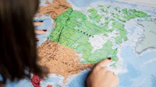 Une femme consulte une carte du Canada.