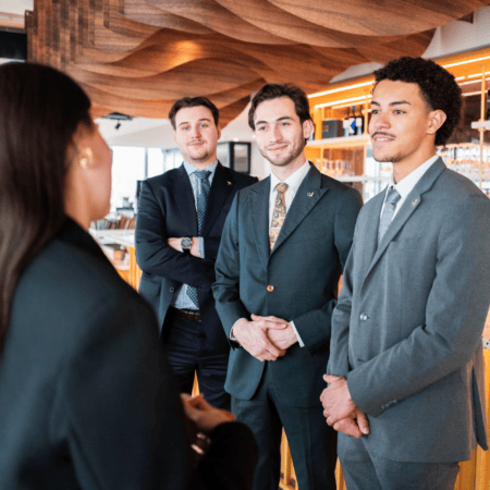 Groupe dhommes en costume au bar dhôtel, discussion professionnelle dhospitalité.