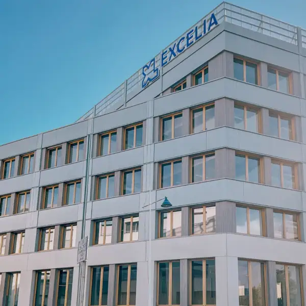 Bâtiment moderne EXCELIA, façade contemporaine à fenêtres régulières sous ciel bleu.