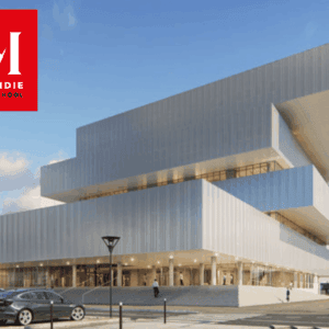 Façade du campus EM Normandie, école de commerce moderne à volumes empilés.