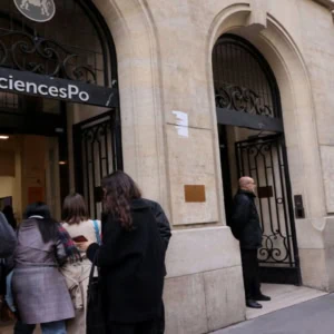 Sciences Po Paris, entrée rue Saint‑Guillaume avec étudiants et sécurité lors des examens.